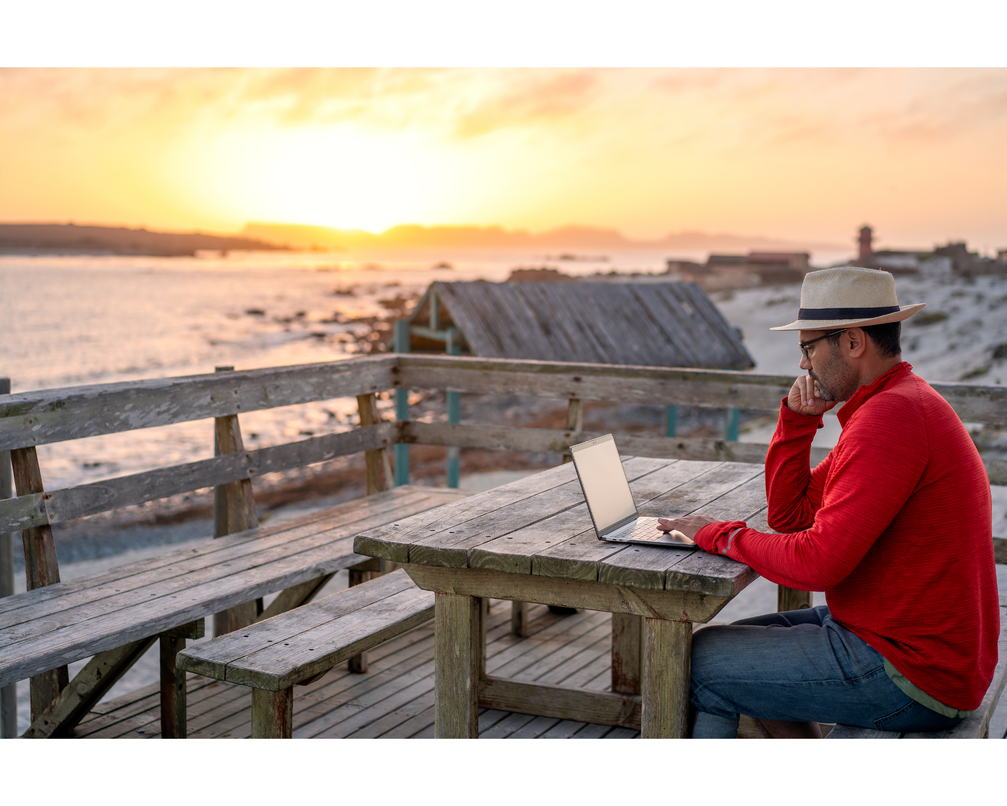 man sitting sunset laptop working